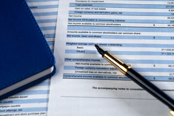 Business report or financial statement with notebook and pen. Accounting management and analysis market and portfolio.