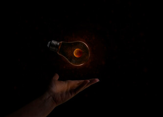 hand holding a light bulb