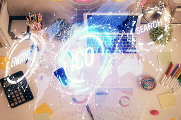 Blockchain theme hologram drawings over computer on the desktop background. Top view. Multi...