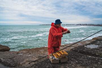 Fisherman with fishing equipment box.
