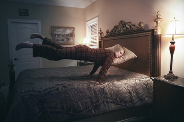 Floating woman sleeping above bed