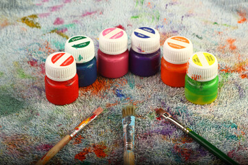 Artistic brushes close up. Watercolor paints in the background. Background with brushes and paints.