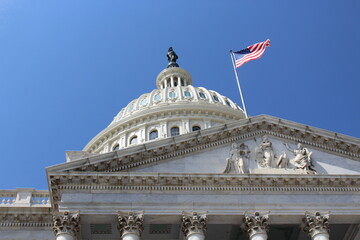 Waving American Flag - US Capital Dome - The dome of the American Congress with a blue sky
