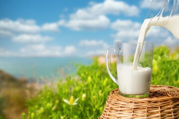 Cup of fresh milk on a natural background
