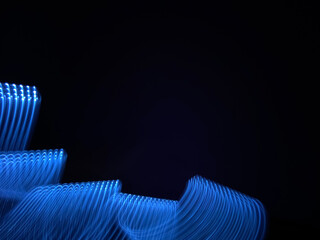 Beautiful graphic shapes made of light with a long exposure. Background pattern in shades of classic blue color of the year 2020.
