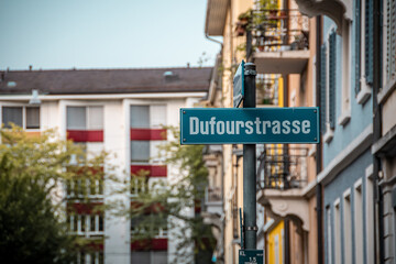 Green street sign. Signpost with street name in German. European city.