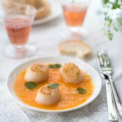 Pan Seared Sea Scallops with Orange Tomato Sauce. Glass of Rose Wine
