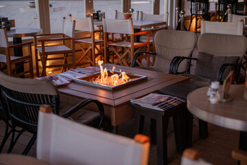 fire on the table in a cozy cafe in pastel colors