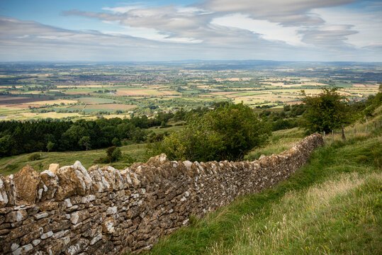 Dry stone wall with view of the Malvern Hills and Evesham plain from Bredon Hill, Worcestershire England UK