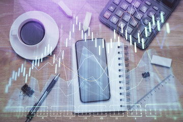 Multi exposure of forex graph hologram over desktop with phone. Top view. Mobile trade platform...