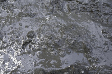 Mud texture or wet gray soil as natural background.