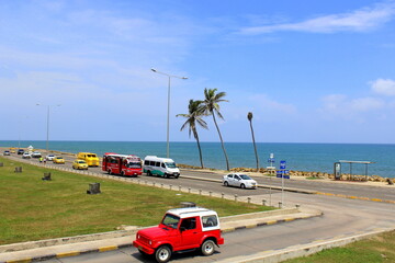 View of the sea, palms, cars, and roads in Cartagena, Colombia.