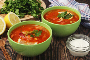 Two bowls with traditional Russian soup solyanka