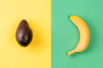 Creative layout made of banana and avocado on colorful background. Minimal summer concept. Fruits design. © photo-lime
