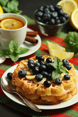 Belgian waffles with blueberry and a cup of tea with lemon