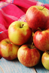 Several ripe red apples on the wooden table	
