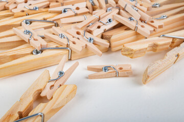 Small and large wooden clothes pegs. Household accessories. White background.