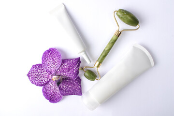 Cosmetic bottle containers with orchid on white background, Blank label for branding mock-up, Natural beauty product concept.