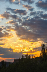 Landscape with dramatic light - beautiful golden sunset with saturated sky and clouds.