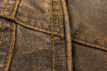 clothing items stonewashed cotton fabric texture with seams, clasps, buttons and rivets, macro