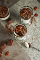 Creamy coffee pudding with chocolate chips and pecans in different glasses. Light dessert. Healthy eating.