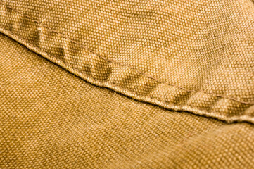 clothing items stonewashed cotton fabric texture with seams, clasps, buttons and rivets, macro