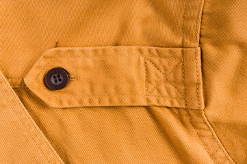 clothing items stonewashed cotton fabric texture with seams, clasps, buttons and rivets, macro