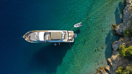 Aerial drone photo of large yacht - boat anchored in tropical exotic paradise bay with emerald open ocean