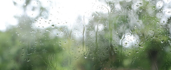 View through the window to garden of house, raining. Rainfall outside the window or outside the...
