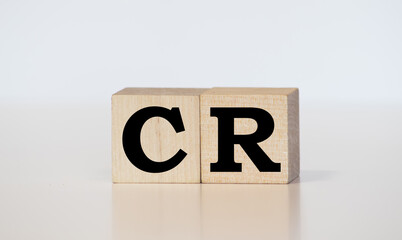 CR word background on wood blocks. business concept