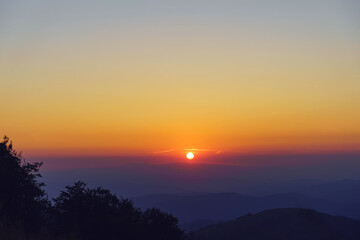 Mountain landscape in sunrise or sunset - Foggy image of hills covered with forest and sky - freedom nature tourist destination concept - stara planina Old Mountain in Serbia
