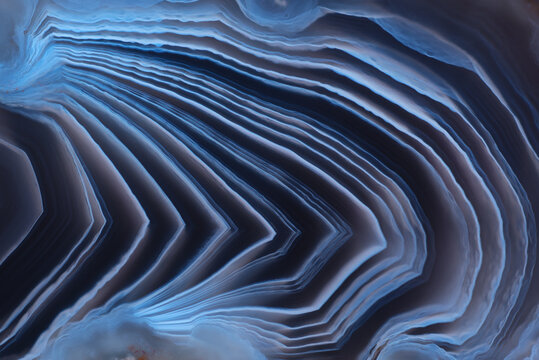 Full-screen texture of natural agate stone with a contrast dark blue and white pattern