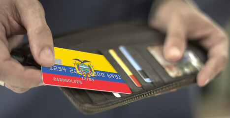 Pulling plastic card with flag of Ecuador out of the wallet, fictional card number