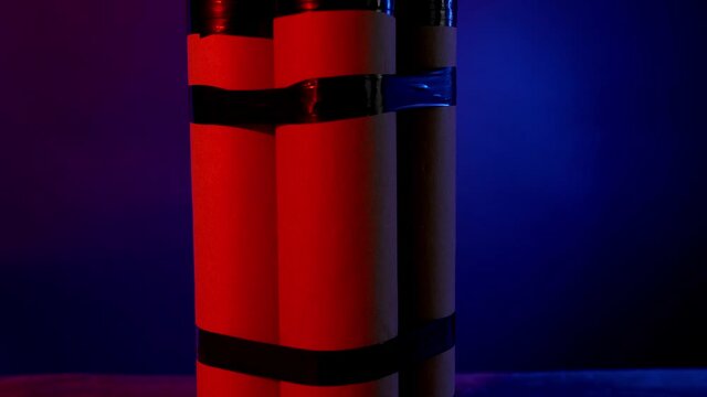 Rotating dynamite bomb on dark background