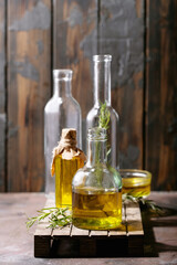 Olive oil with rosemary in glass bottles