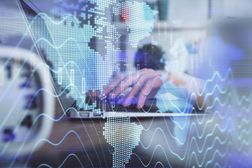Double exposure of woman hands typing on computer and forex chart hologram drawing. Stock market...