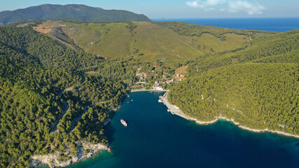 Aerial drone photo of small picturesque fjord looking port of Agnontas covered in pine trees ideal for safe anchoring, Skopelos island, Sporades, Greece