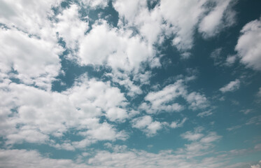 Idyllic beautiful deep blue sky, with scattered white fluffy clouds. Nature is simply amazing