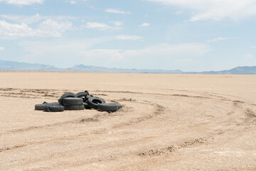 Fototapeta na wymiar Used old tires illegally dumped in the desert. 