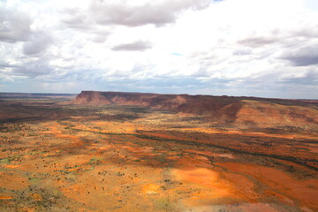 An incredible aerial view over the dry desert landscape of George Gills Range and Kings Canyon, Northern Territory, Australia