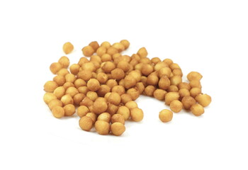 Fried batter pearls in a clay bowl. Crispy pearls. A soup topping and snack product made from flour, vegetable fat and yeast. Isolated macro food photo close up from above on white background.