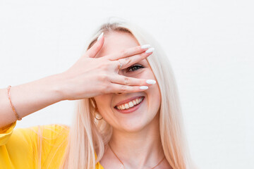 Obraz premium Happy woman looking between fingers