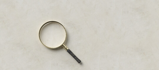 magnification glass on the left on empty paper background