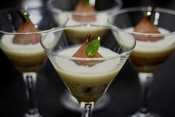 Glass of pear dessert with cream