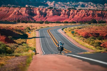 Fototapeten Biker driving on the Highway on legendary Route 66, Arizona. Panoramic picture of a scenic road, USA. © Volodymyr