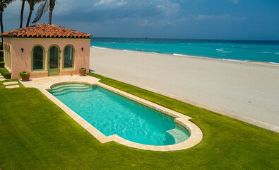Beach house on sea with swimming pool and view in retro vintage design.