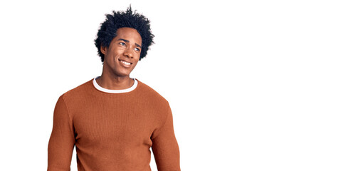 Fototapeta premium Handsome african american man with afro hair wearing casual clothes smiling looking to the side and staring away thinking.