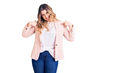 Young caucasian woman wearing business clothes looking confident with smile on face, pointing oneself with fingers proud and happy.