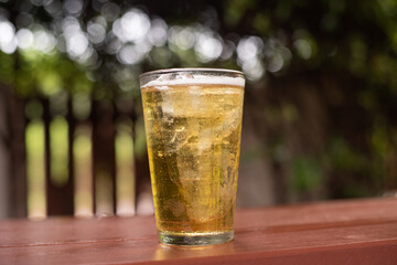 Glass of beer on dark background.