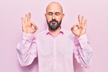 Naklejka premium Young handsome man wearing business clothes relax and smiling with eyes closed doing meditation gesture with fingers. yoga concept.